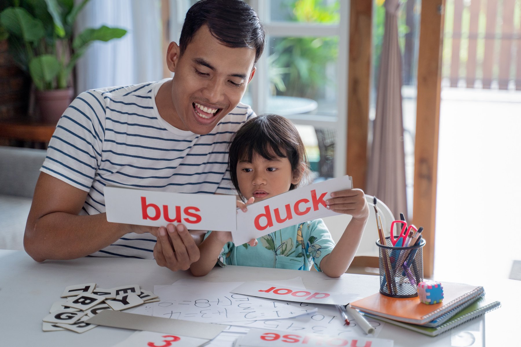 Girl Studying Word with Father at Home